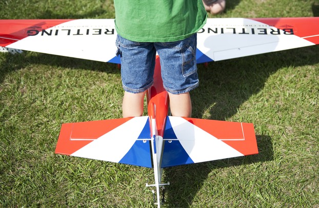 Eoin Hubbard, 8, stands over a remote control airplane at the 29th Flying Pilgrims Radio Control Club event on Sunday. Daniel Brenner I AnnArbor.com